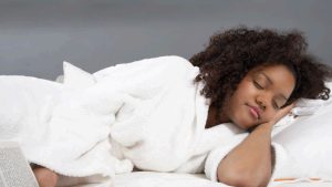 a happy sleep podcast listener a young black woman, fast asleep Sleepy Time Tales Sleep Podcast home